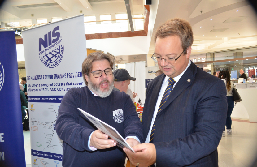 Mike talks to a local employer at his 2023 Jobs & Skills Fair