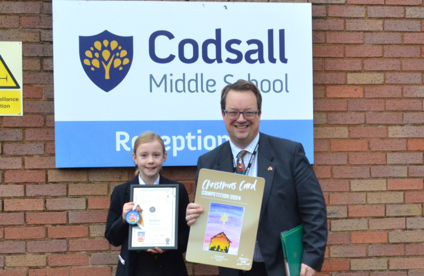 Mike with Christmas card competition winner Isla Gaunt at Codsall Middle School