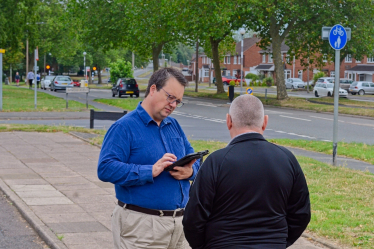 Mike listening to a constituent on one of his “Tell Mike” summer tours